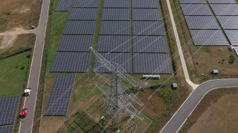 Aerial view of solar panels and power line pylon in the netherlands Stock Footage 341874925
