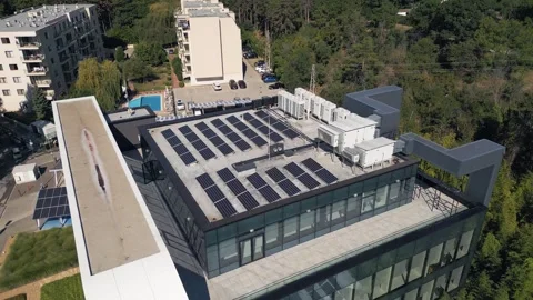 Aerial View of Solar Panels and HVAC Equipment Installed on Modern Building Roof Stock Footage 346698616