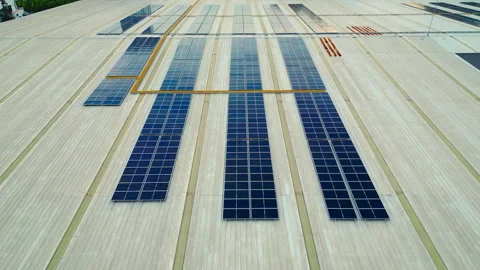 Aerial view of solar panels array installed on a large rooftop in a sunny Video stock 304243072