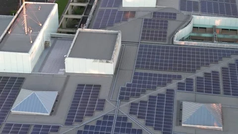 Aerial view of solar panels on data centre roof at dusk Stock Footage 348042403