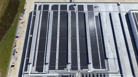 Aerial view of solar panels on a distribution centre, United Kingdom. Stock Footage 333356851