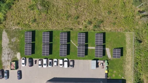 Aerial view of solar panels generating clean energy in a car parking lot Stock Footage 347878621