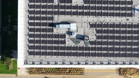 Aerial view of solar panels installed on a flat commercial building rooftop Stock Footage 345155393