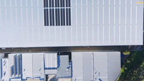 Aerial view of solar panels on a large warehouse roof Stock Footage 341254957