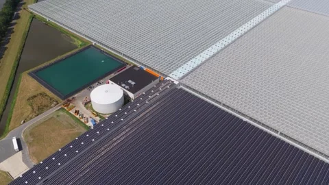 Aerial view of solar panels powering industrial greenhouses Stock Footage 340350111