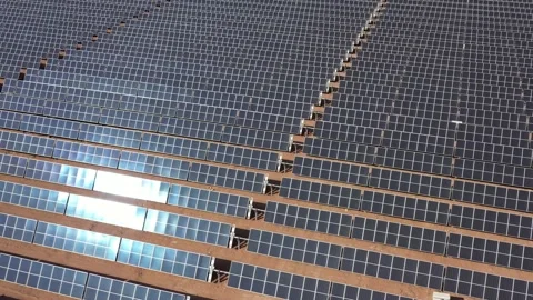 Aerial view of solar panels with sun reflection at the warm heat desert. Green Stock Footage 164875179