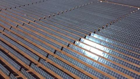 Aerial view of solar panels with sun reflection at the warm heat desert. Green Stock Footage 164875283