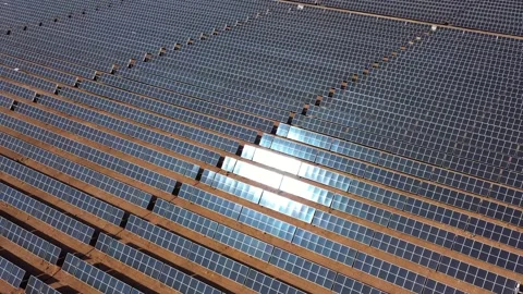 Aerial view of solar panels with sun reflection at the warm heat desert. Green Stock Footage 164875402