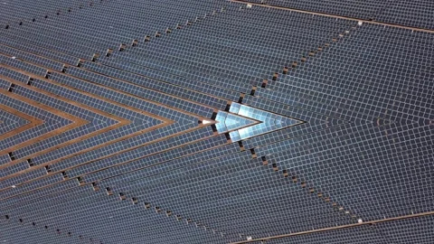 Aerial view of solar panels with sun reflection at the warm heat desert. Green Stock Footage 164875555