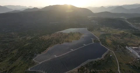 Aerial view of solar panels at sunset with dramatic sky Stock Footage 324509716