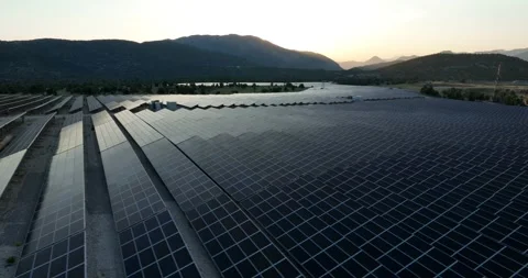 Aerial view of solar panels at sunset with dramatic sky Stock Footage 324509906