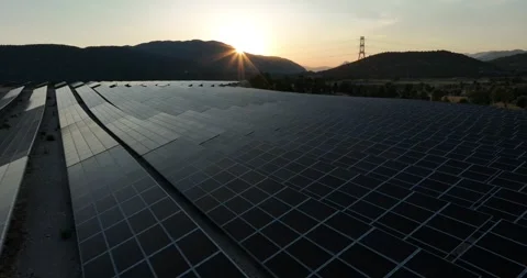 Aerial view of solar panels at sunset with dramatic sky Stock Footage 324510099