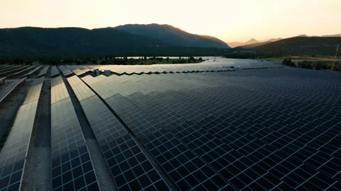 Aerial view of solar panels at sunset with dramatic sky Stock Footage 324543377