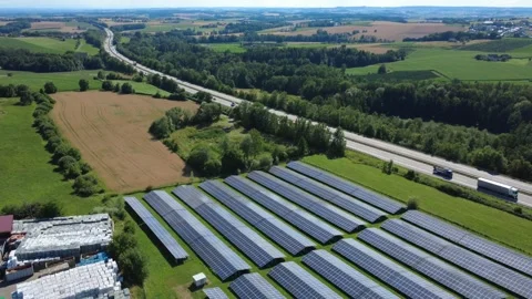 Aerial view of a solar park next to a highway in the countryside Video stock 339274667