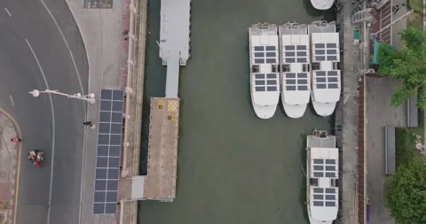 An aerial view of Solar powered shuttle boats parked at the solar port Stock Footage 274823267