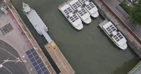 An aerial view of Solar powered shuttle boats parked at the solar port Stock Footage 274823279