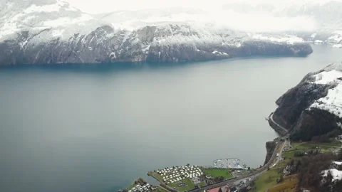 Aerial view of some lake surrounded by mountains in Swiss Alps in winter Stock Footage 224538385