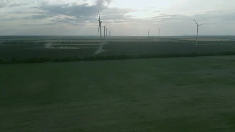 Aerial view of some operating air turbines in a field off the coast Stock Footage 184632385