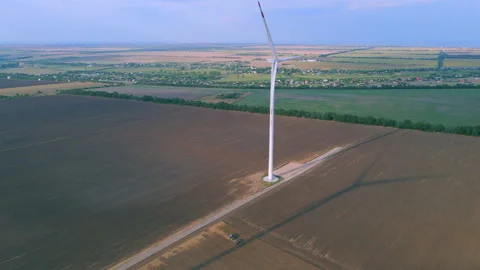 Aerial view of some operating air turbines in the middle of the cultivated field Stock Footage 184635452