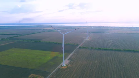 Aerial view of some operating air turbines in a field near the coast Stock Footage 184636649