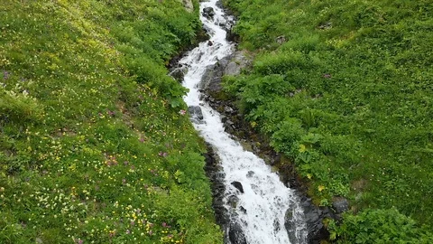 Aerial view the source river high in the mountains, melting glaciers Caucasus Stock Footage 116090716