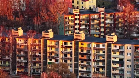 Aerial view of Soviet era apartment buildings illuminated by golden hour 库存影片 336307400