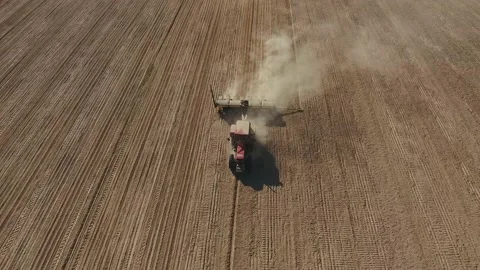 Aerial view of sowing corn and wheat in the field. A tractor is planting a grain Stock Footage 223531840