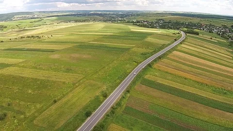 Aerial view of the sown fields near the motorway Stock Footage