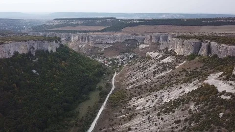 Aerial View: a span in the middle of a canyon, on one side of the cliff, on the Stock Footage 82686824
