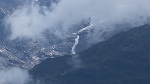 Aerial view of a spectacular waterfall through the clouds Stock Footage 317656207