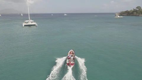 Aerial view of a speed boat cruising on the waters on Sosua Beach, DR  (Raw) Stock Footage
