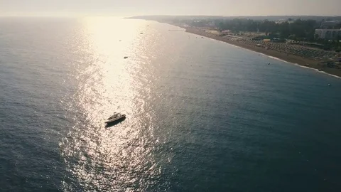Aerial view speed boat float near the coast in calm water on a sunny day. Sun Stock Footage 77488631