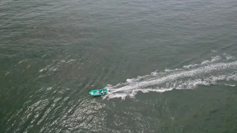 Aerial View of Speedboat on Ocean with Distant Coastline and Islands Stock-Footage 336452630