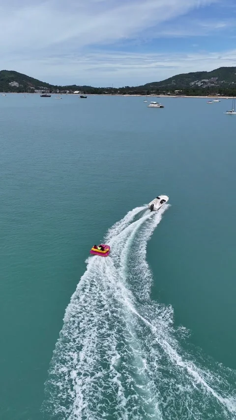 Aerial View of Speedboat Pulling Inflatable Tube in Koh Samui, Thailand Stock Footage 335826180