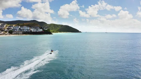 Aerial view a speeding jet ski on Ffryers beach in Antigua and Barbuda 動画素材 233225244