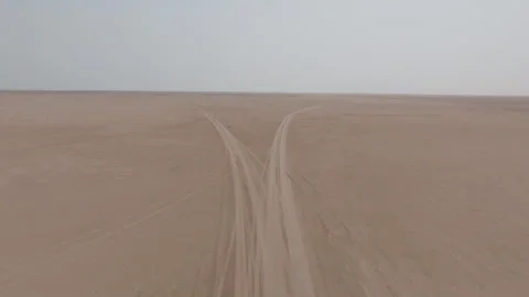 Aerial view of split tracks in Oman’s desert leading to Bar al Hikman Stock Footage 305243897