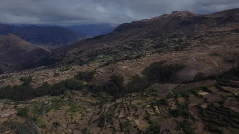 Aerial view of sprawling patchwork farm plots, rural Andean settlements, and Stock Footage 346632437