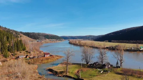 Aerial view of the spring flowing river, surrounded by hills. Stock Footage 106275943