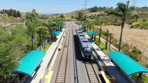 Aerial View of SPRINTER Train Arriving at El Camino Real Station in Oceanside Stock Footage 334620831