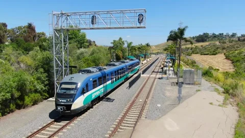 Aerial View of SPRINTER Train Departing El Camino Real Station in Oceanside Stock Footage 334620832