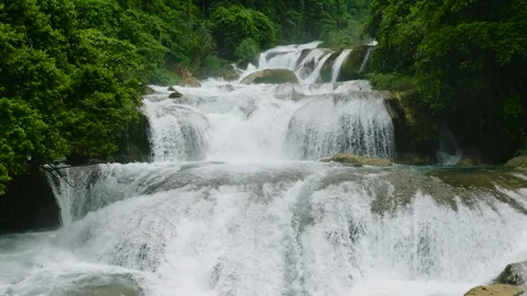 Aerial view of stair like rock formations in Aliwagwag Falls. Slow motion. Stock Footage 252957314