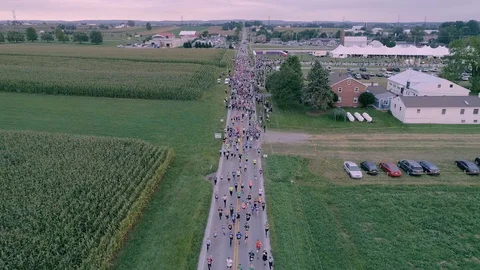 Aerial View of the Start of a 5K Marathon Race on a Cloudy Summer Day Stock Footage 118779175