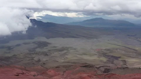 Aerial view that start with red sand and goes over a green valley next to the Stock Footage 142747252