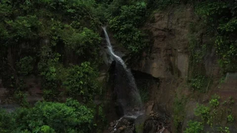 Aerial view starting in front of a  waterfall and zooming out to a bird eye view Stock Footage 142748194