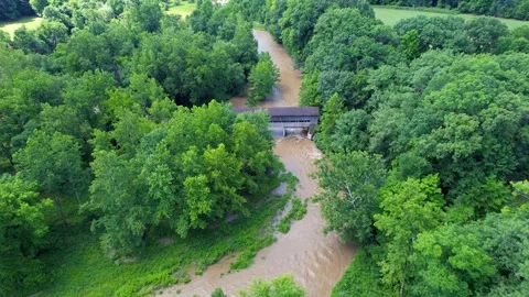 Aerial view of State road covered bridge over river in Ohio Stock Footage 339262972