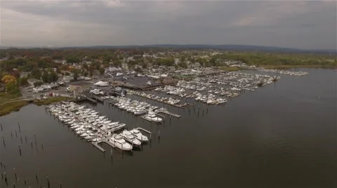 Aerial view of Staten Island. Camera hovering right over boats moored in Marina. Video stock 58570933