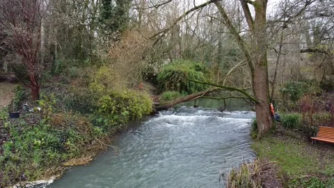 Aerial view, static camera. River in the garden in the village of Malmsbury, UK. Stockbeeldmateriaal 138208893