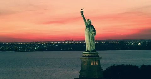 Aerial view of the Statue of Liberty orbiting   at sunset, New York City, during Video stock 199458080