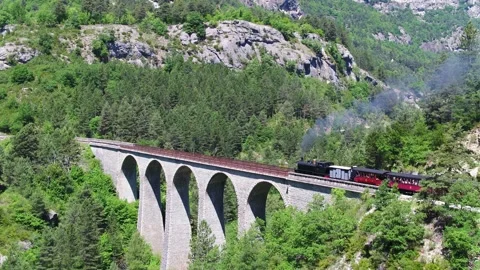Aerial view, steam train between Annot and Entrevaux, Var Valley, France. Video stock 132892576