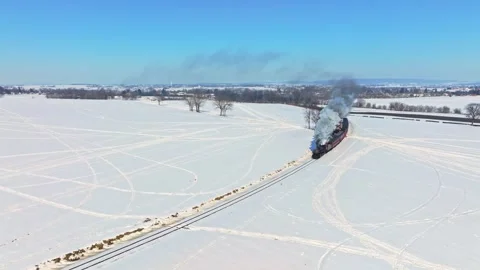 Aerial view of a steam train in the snow, United States. Stock Footage 341954312